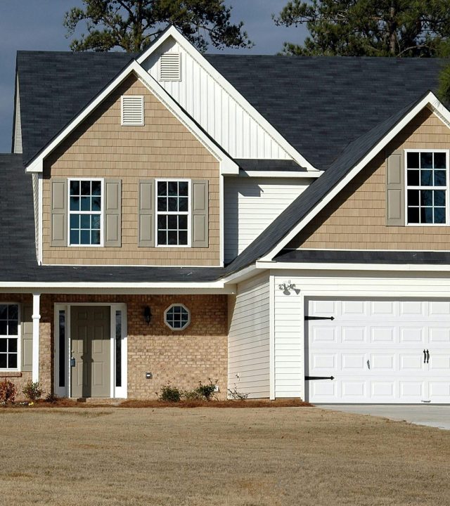 pexels-photo-164558-164558 Elegant two-storey house with garage, showcasing modern architecture and residential charm.